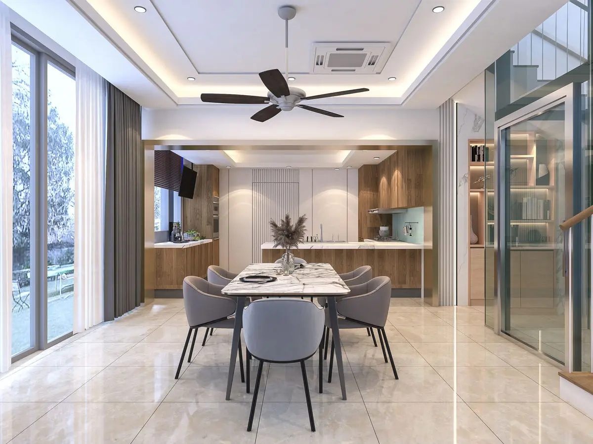 Dining area with a round table and upholstered chairs, glass door through to the kitchen