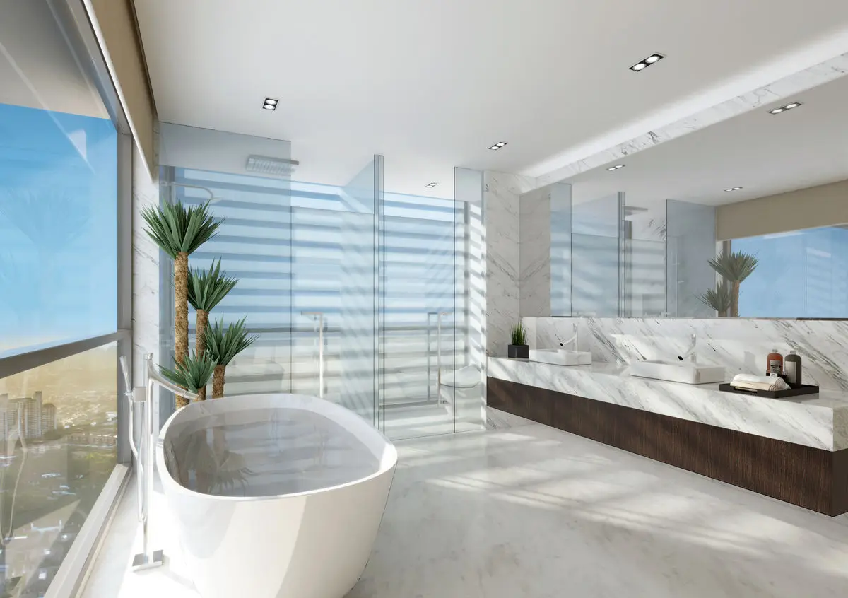 Bathroom with a freestanding tub by a full-height window and a marble-clad wall