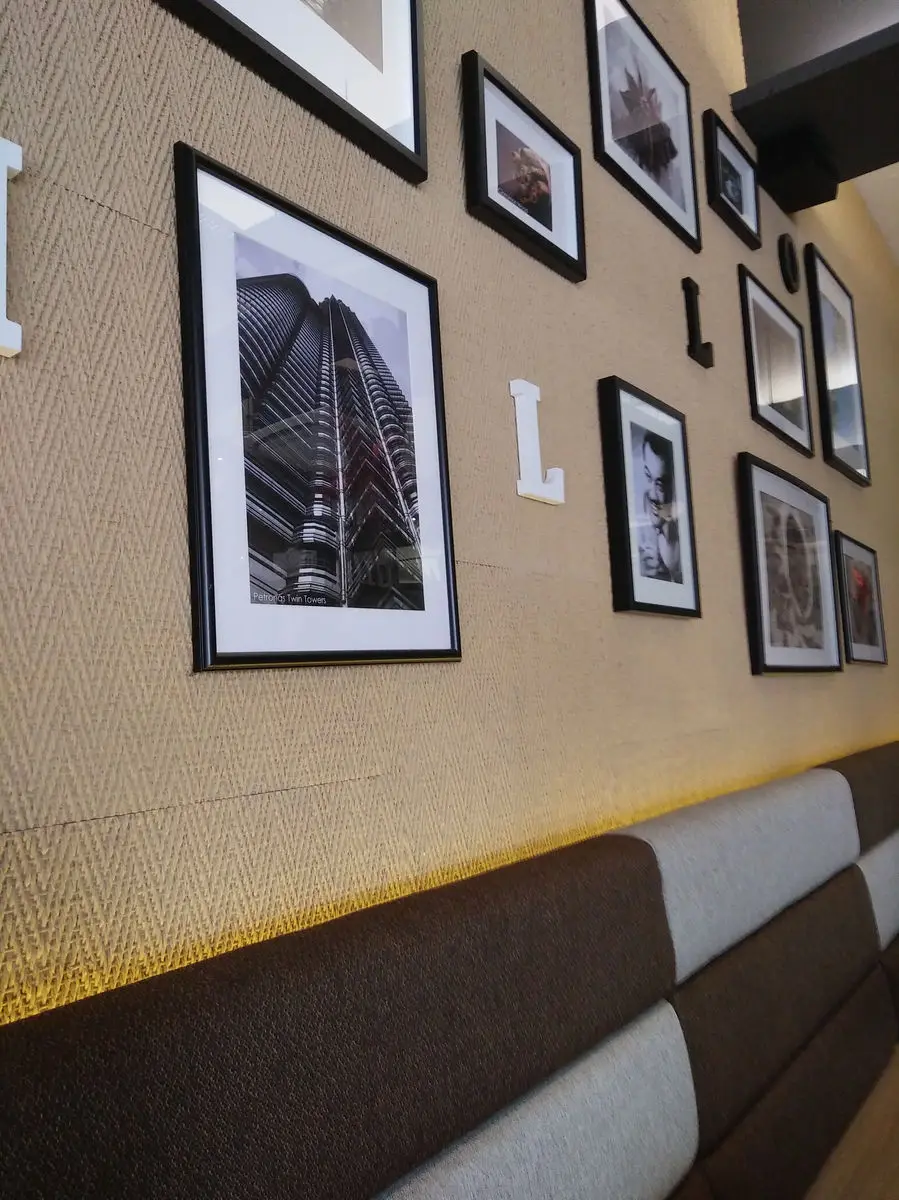 Banquette seating below a gallery wall of framed prints