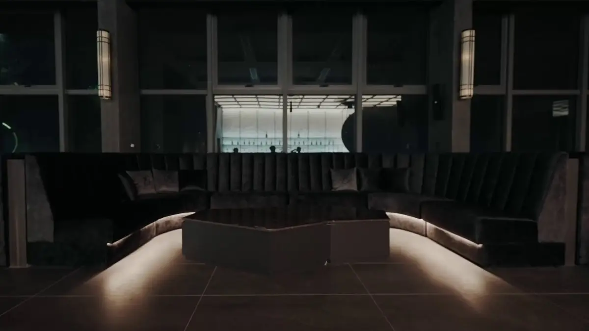 Curved seating booth with concealed strip lighting in a dark interior