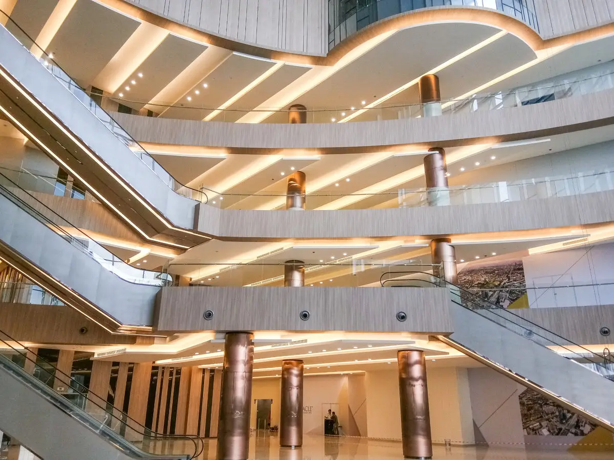 Atrium looking up through curved timber-lined balconies and escalators
