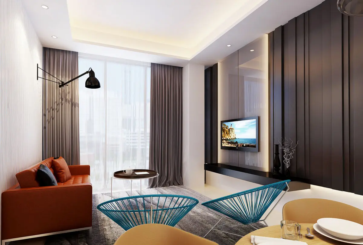 Living area with a rust sofa, TV on a dark timber wall and dining chairs in the foreground