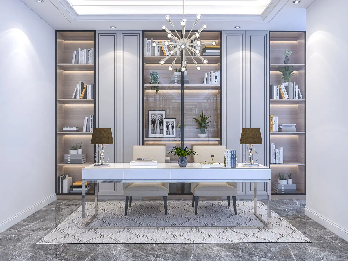 Study with a white desk between backlit bookshelves and a sputnik chandelier