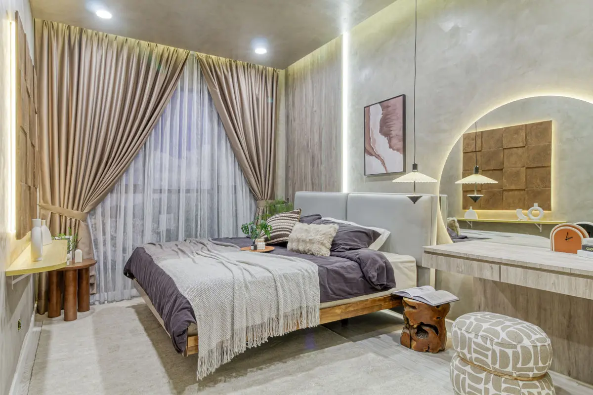 Bedroom with an arched headboard panel, timber bed frame and a curved dressing counter