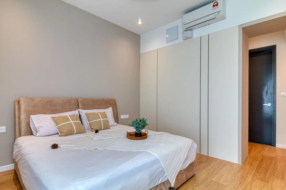 Bedroom with an upholstered headboard, built-in wardrobe and timber flooring