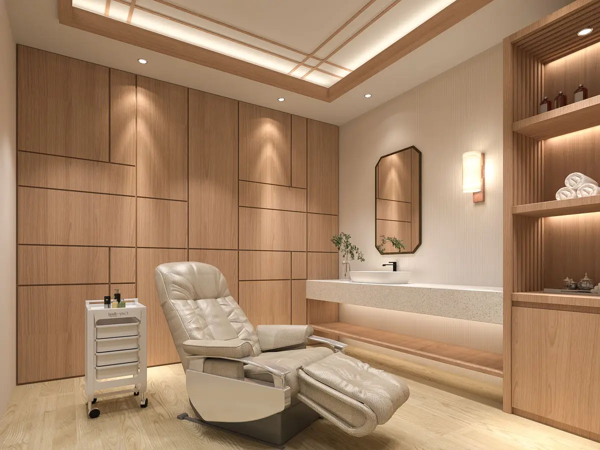 Treatment room with a reclining chair, panelled walls and open shelving