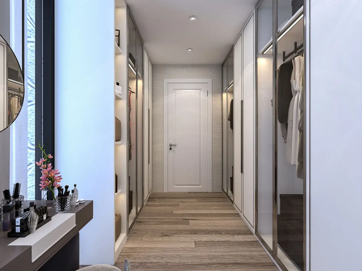 Dressing corridor with mirrored wardrobes, a vanity counter and timber flooring