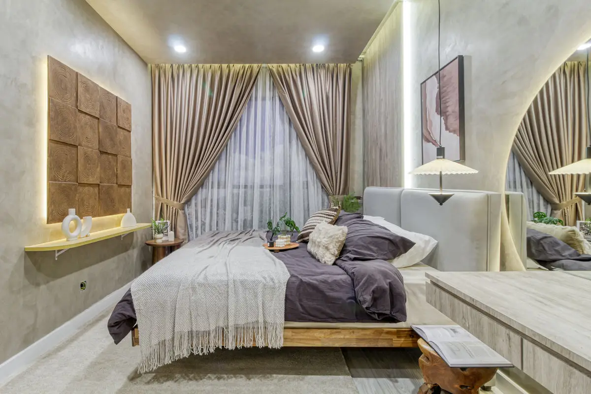 Bedroom with a padded panel headboard, arched mirror and timber platform bed