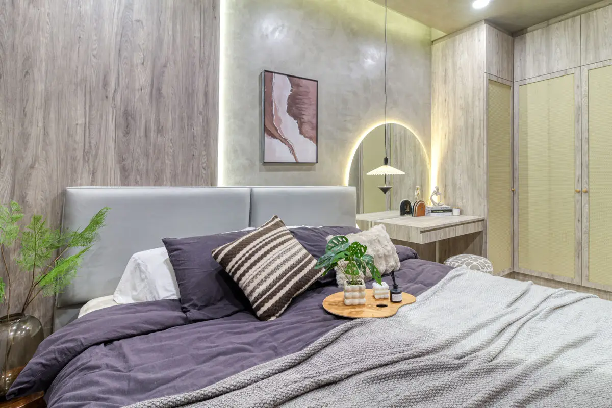 Bedroom with a micro-cement wall, arched pendant light and a built-in dressing counter