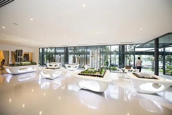 Display hall with landscaped model tables under a glazed wall