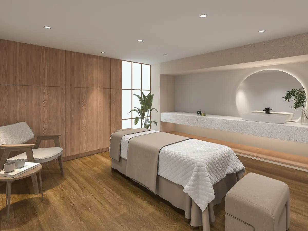 Treatment room with timber panelling, a massage bed and a long counter