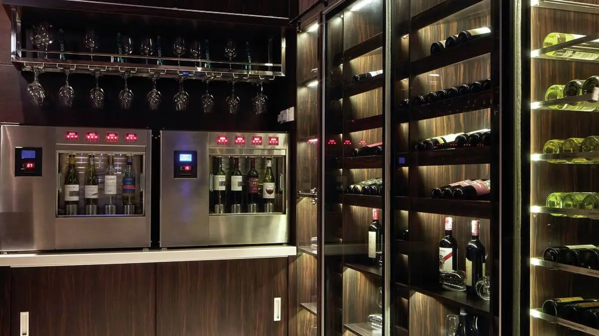Wine dispensing station with backlit bottle display shelving