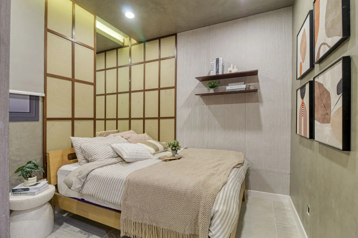 Bedroom with a shoji-style timber screen wall, timber bed and framed prints