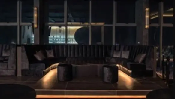 Lounge booth in dark timber with concealed lighting and city views