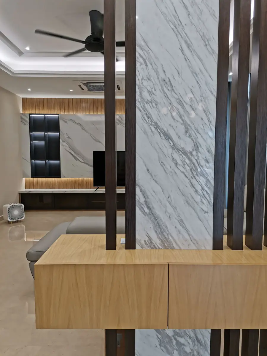 Close view of a slatted timber divider against a marble wall and low cabinet