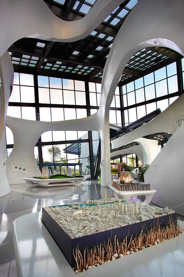 Atrium interior with sculptural columns and a model display in the foreground