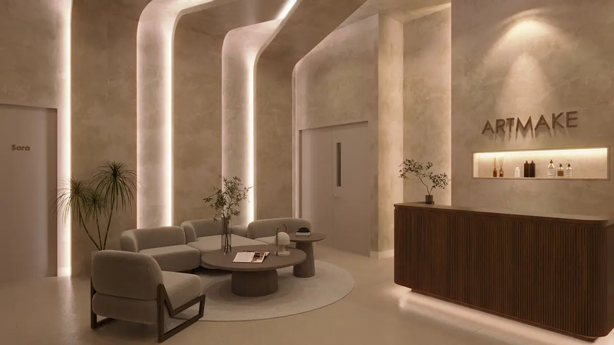 Reception area with fluted columns, a curved sofa and backlit brand signage