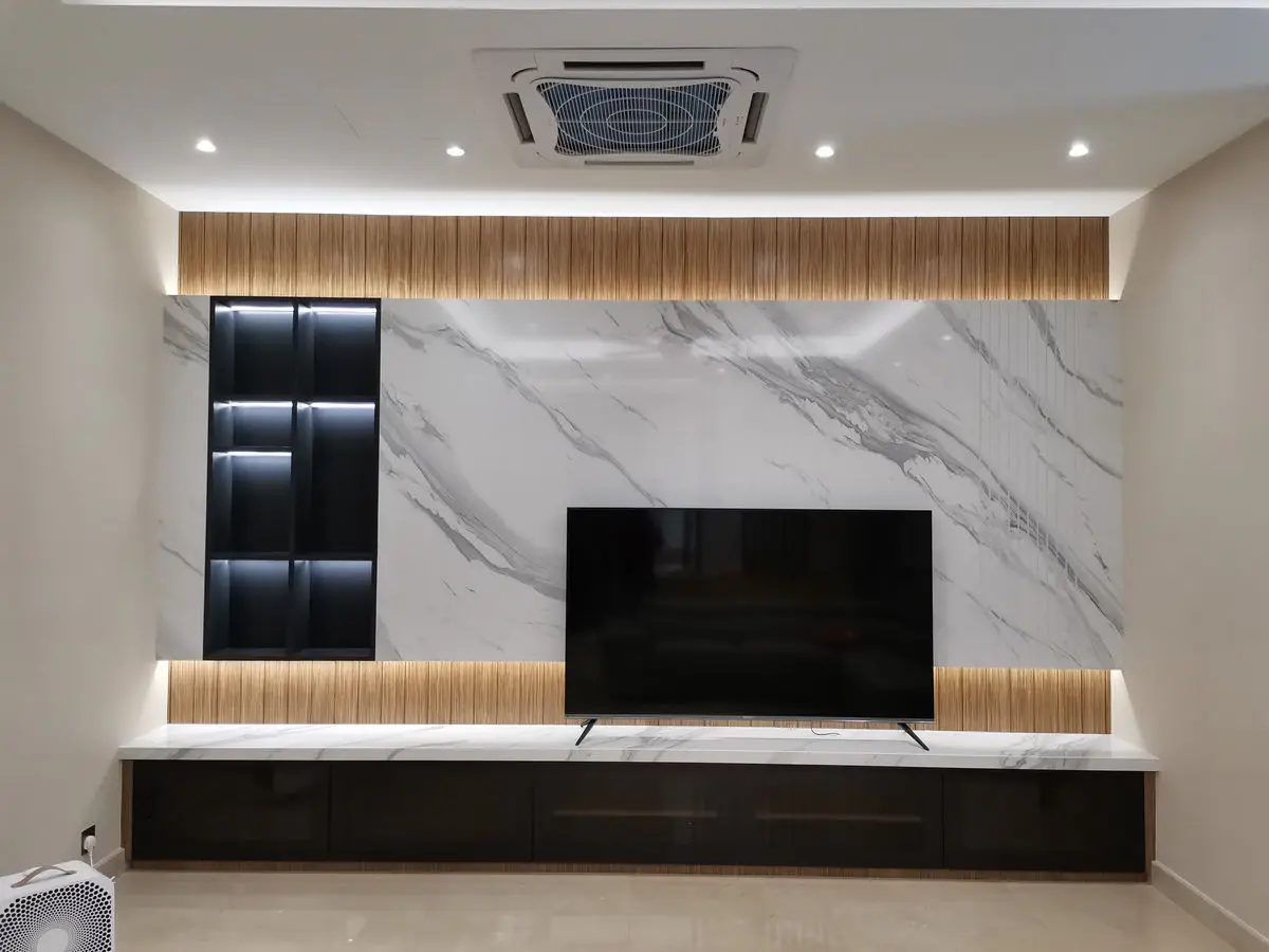 Marble TV feature wall with black leather upholstered panels and a full-width low console