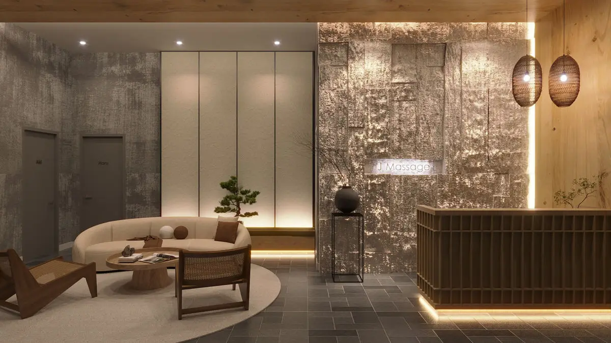Lounge with a stone feature wall, timber reception counter and armchairs