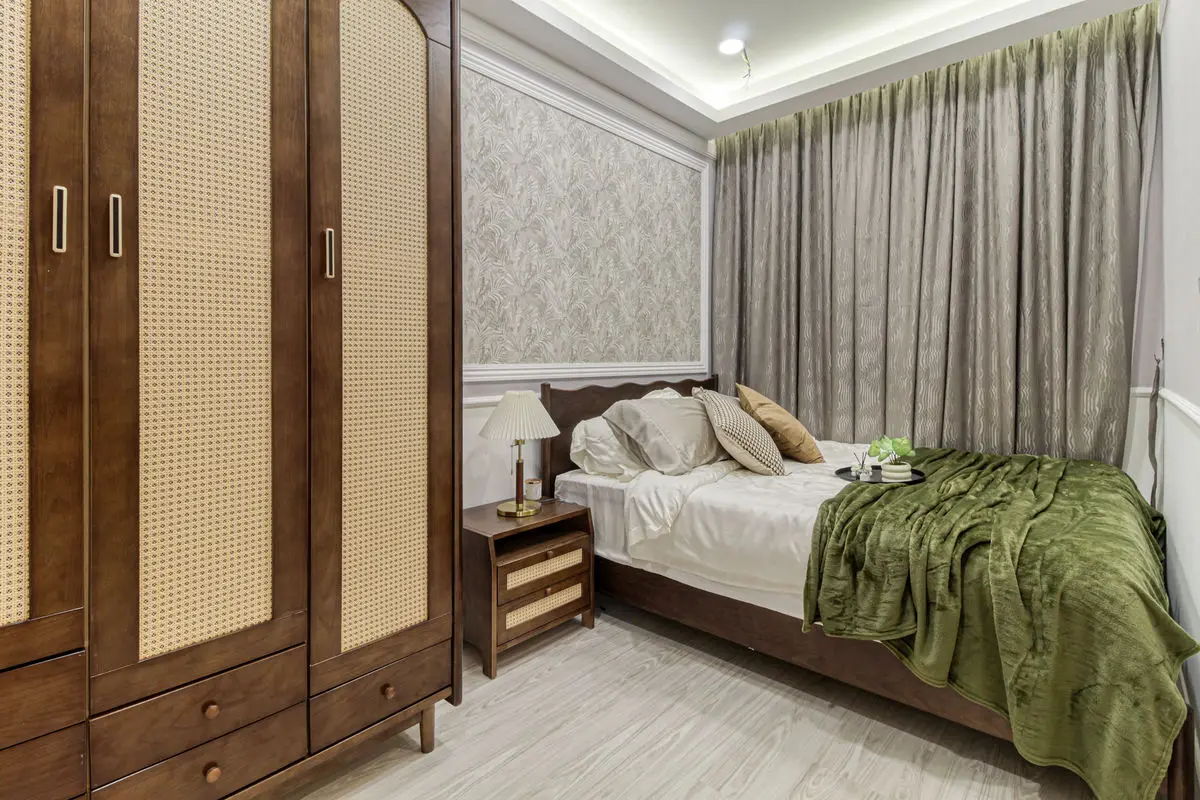 Compact bedroom with a rattan-fronted wardrobe and a timber bed frame