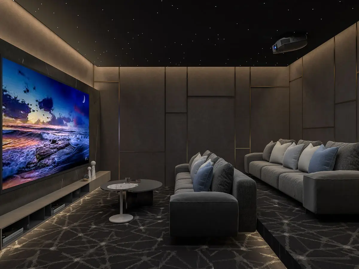 Home cinema with a projector screen, upholstered wall panels, dark sectional and star ceiling