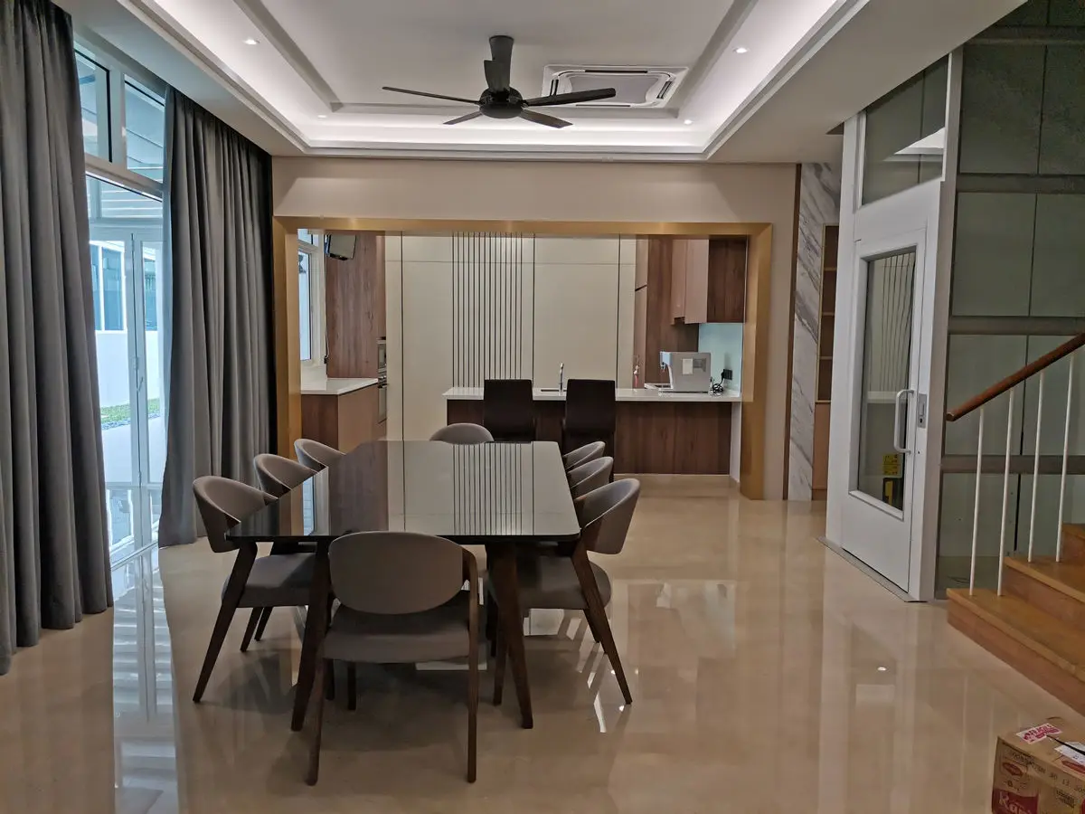 Dining room with a dark timber table and upholstered chairs, opening to the kitchen beyond