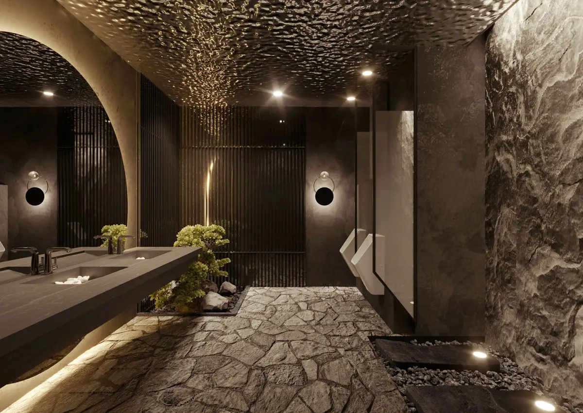 Washroom with rough stone walls, a textured ceiling and a stone-paved floor